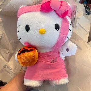 Hello Kitty side, stepper, plush pink, mummy outfit holding pumpkin